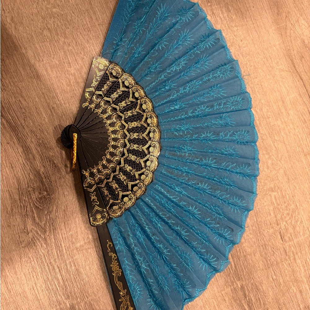 Decorative Fan with black & gold designs & blue patterned cloth & gold handle
